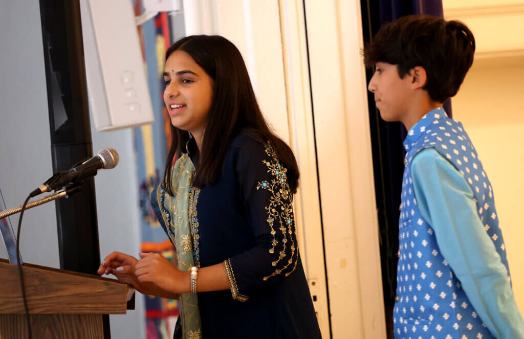 Master of ceremonies Maya Soto, 17, a rising senior at Acton-Carlisle High School, and her brother Shaan Soto, a rising freshman at CCHS, introduce a performer during Acton's second annual India Day celebration at First Parish on August 16, 2025, Ken McGagh/The Acton Bridge