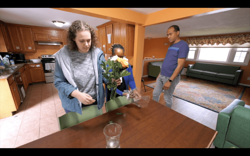 Kensington Roy, seen in the “We Need to Talk” documentary, places flowers she bought at Verrill Farm in a vase. Courtesy photo