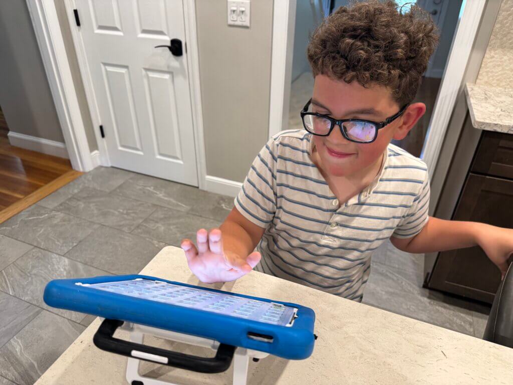 Ethan Martinelli using his AAC device. Courtesy photo