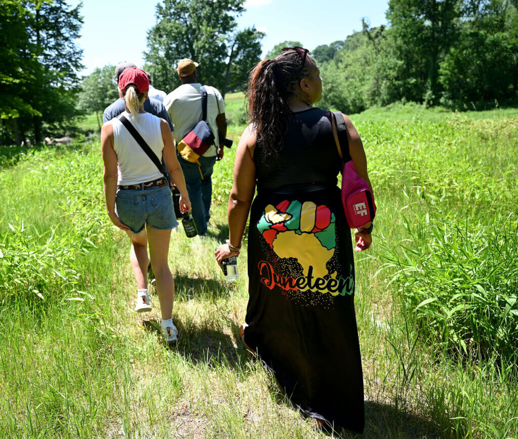 Patrice Malone, wearing her perennial Juneteenth dress, takes part in the Patriots of Color Walking Tour at Minute Man National Historical Park.