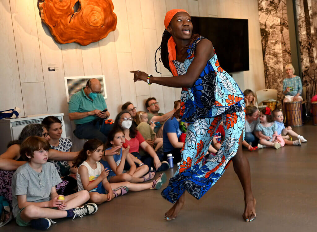 Scynthia Charles of Ammaya Dance & Drum entertains children at the Acton Museum.
