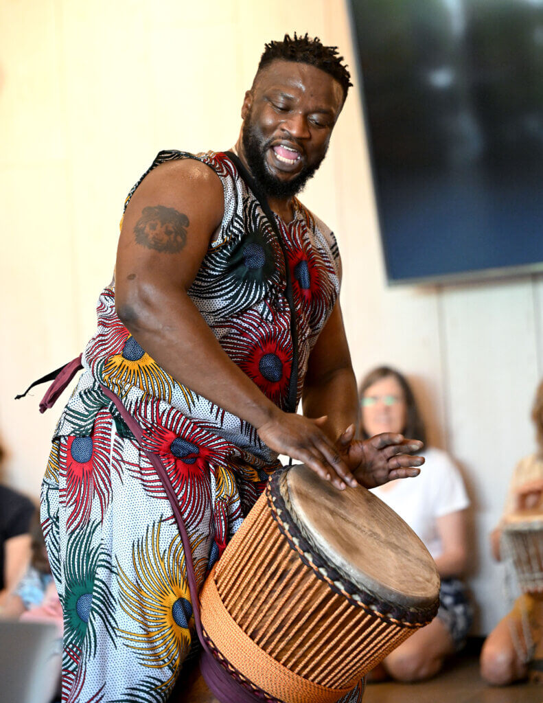 Nko Fallou Fall of Ammaya Dance & Drum plays a djembe during the Acton Museum’s Juneteenth program.