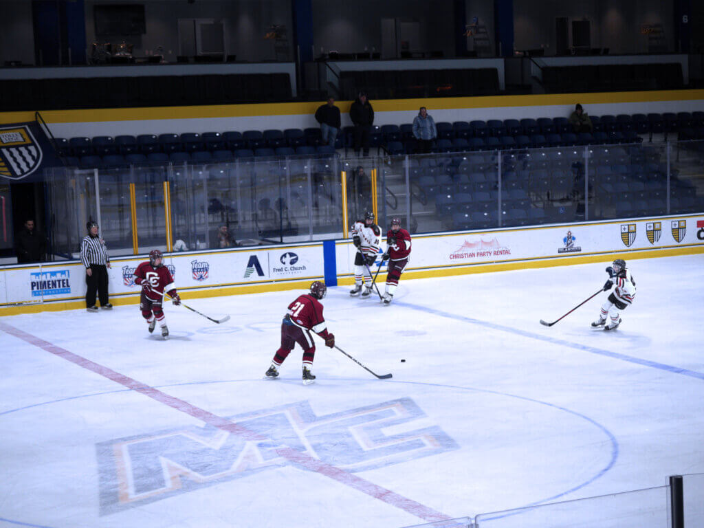 Will Fairbanks gets the puck while Del Colabro watches. Photo by Austin Colabro