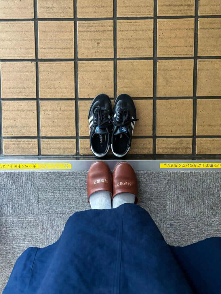 The genkan at Nanae High School is where students and visitors swap outdoor shoes for slippers or indoor shoes before entering. Photo by Emily Aldous
