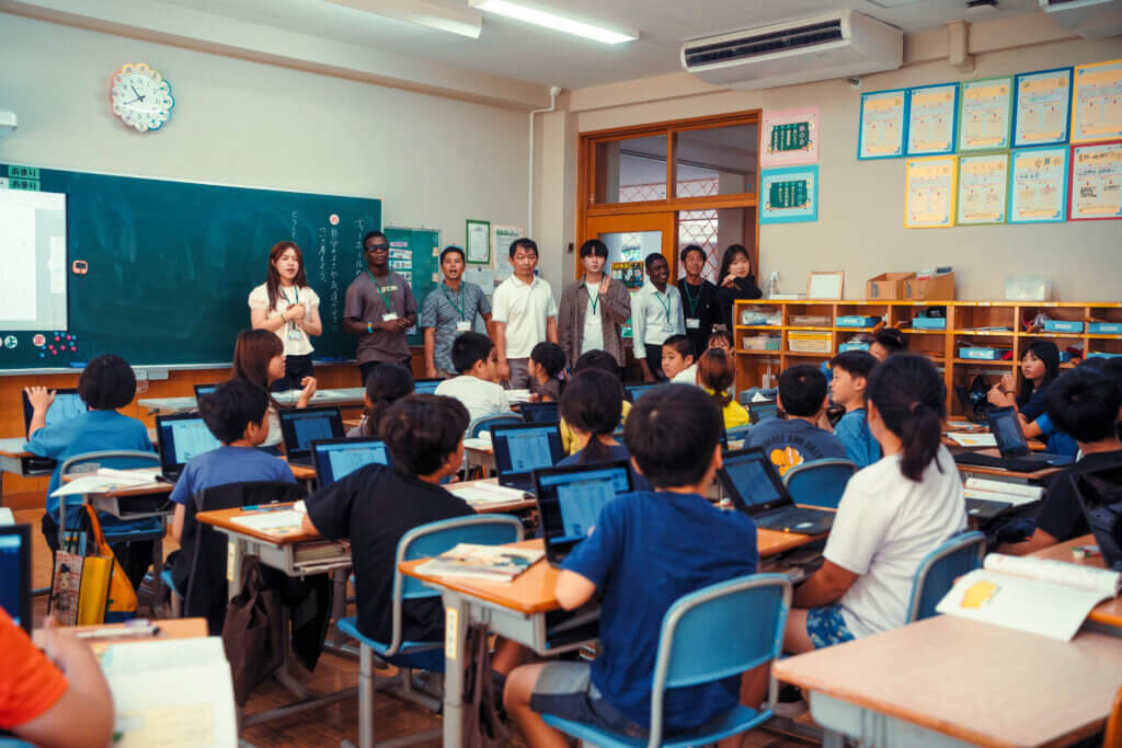 International guests visit a junior high school classroom in Nanae. Photo by Yotam Ivan