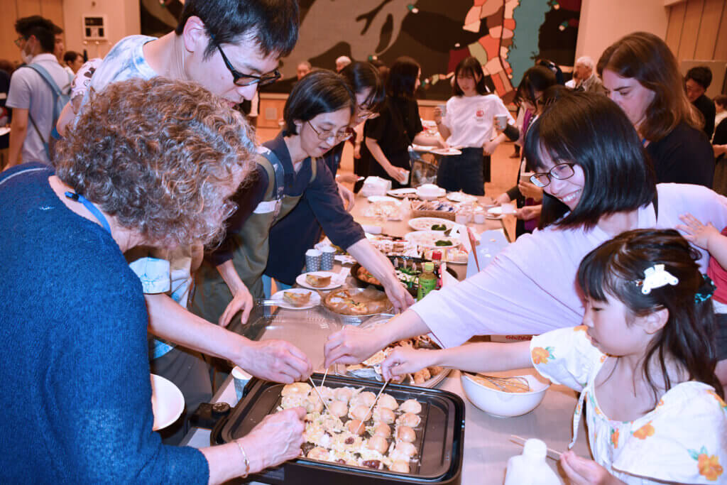 Select Board Clerk Wendy Rovelli, left, making takoyaki. Photo courtesy of Jack Brox McCarthy