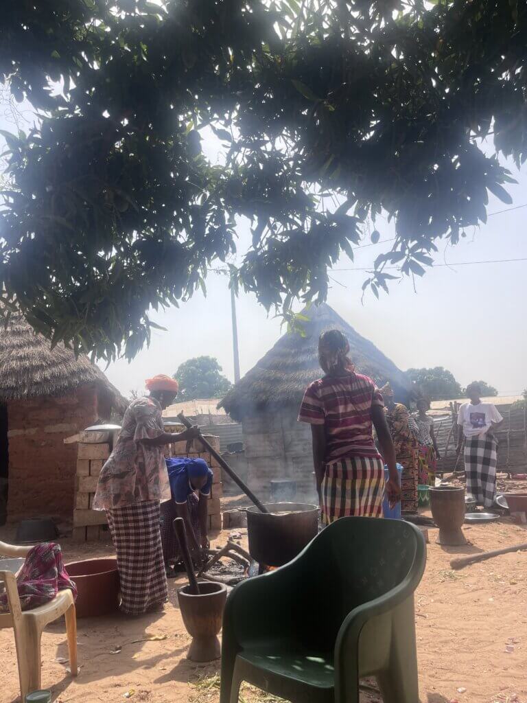 Women of the village cook together. Such chores are often collaborative events that help weave the social fabric of the community. Photo by Mikaela Smith