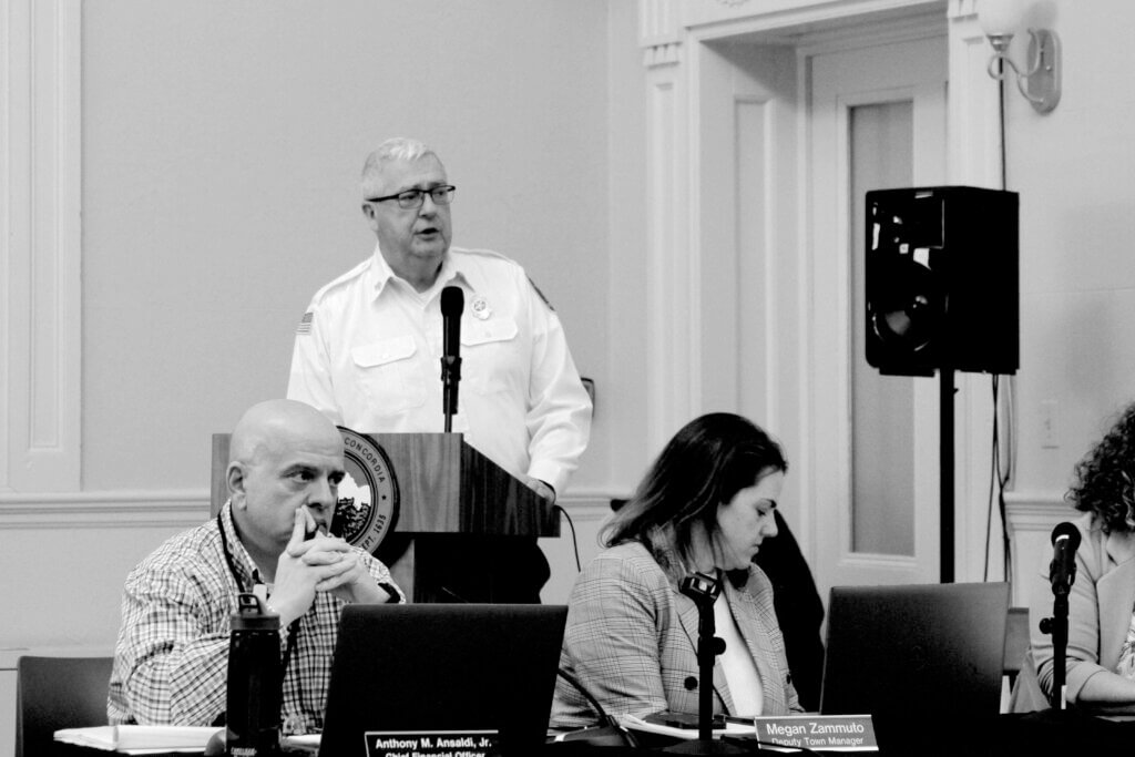 Fire chief Thomas Judge speaks from behind a lectern during a February 10 budget presentation to the Select Board. Photo: Dakota Antelman/The Acton Bridge