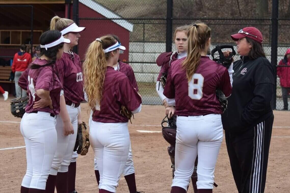 Lisa McGloin, right, former Acton-Carlisle High School softball coach, discusses defensive strategy with her pitcher and infielders. Photo by Laura Mullins