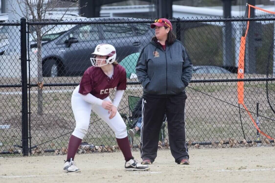 Lisa McGloin coaches as Jill Chelton, on third base, looks to score a run for the Patriots. Photos by Laura Mullins