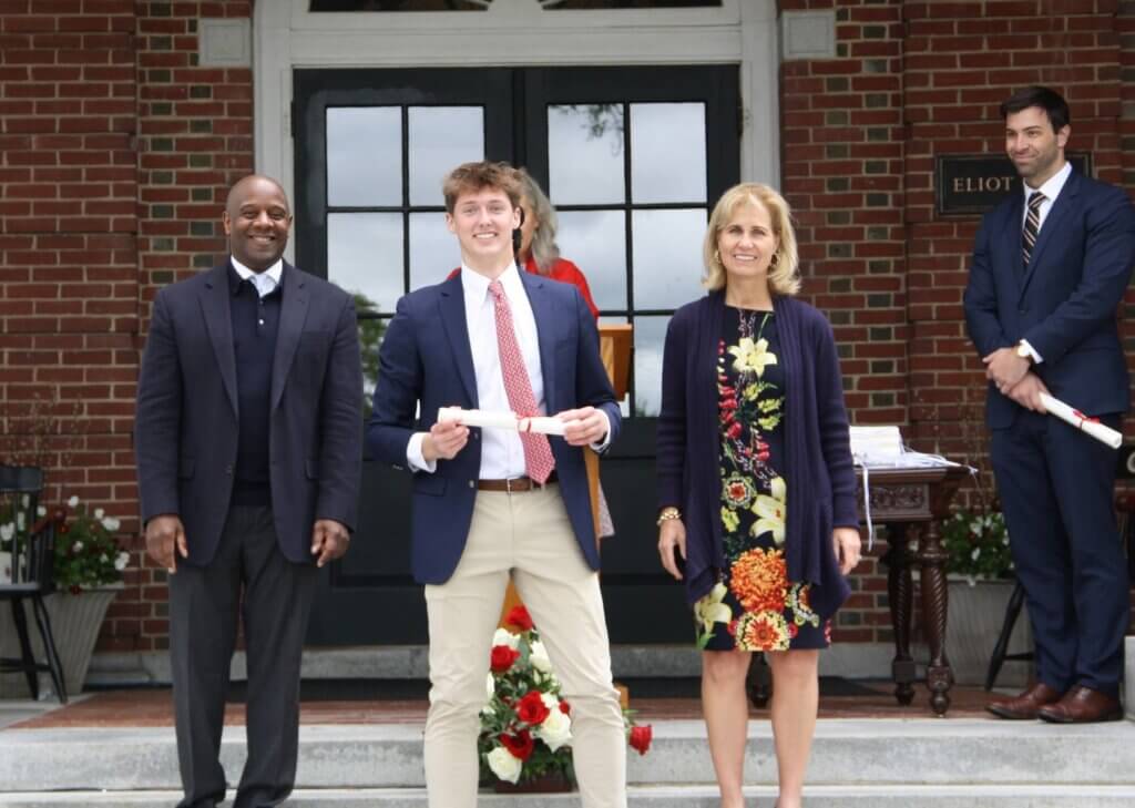 Member of the Class of 2025 at Middlesex School, Jack Francini of Acton is flanked by the school’s Board Chair Jason Robart '83 and Head of School Bessie Speers. A right is Assistant Head of School Eric Kester ’04. Courtesy photo