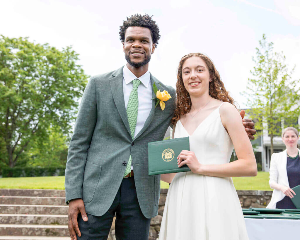 Acton Academy graduate and Acton resident Caroline Comjean, holding her diploma, and Henry Fairfax, head of school, on commencement day. Courtesy photo