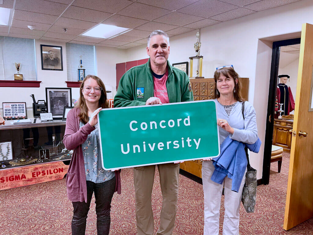 Elizabeth Chandler, Rob Morrison, and Liz Morrison with a Acton University sign. Courtesy photo
