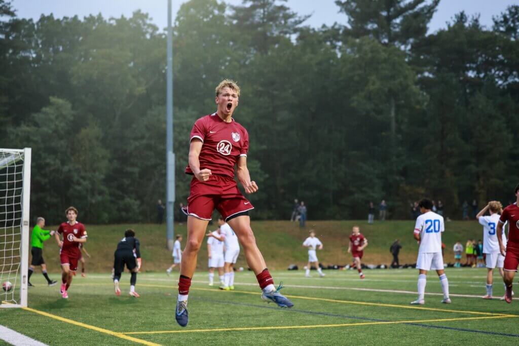 Burke Breimyer levitates in celebration of his goal against Newton South on October 13. Photo by Janel Apuna