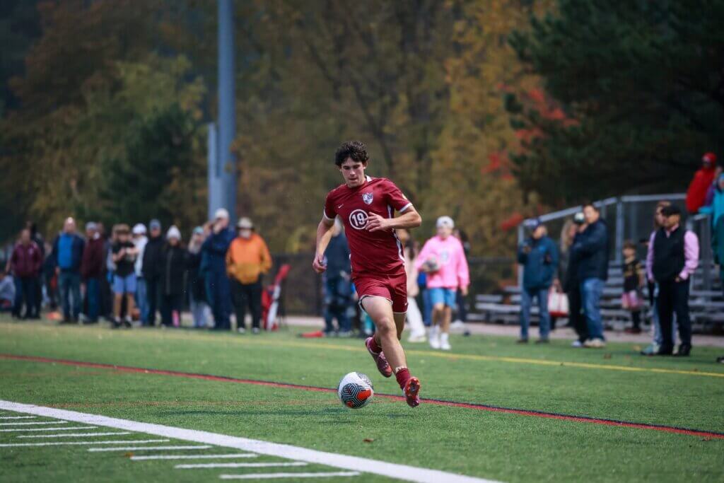 Matan Yosefson moves up the sideline for CCHS. He tallied a goal in the Patriots’ 5-0 win over Newton South. Photo by Janel Apuna
