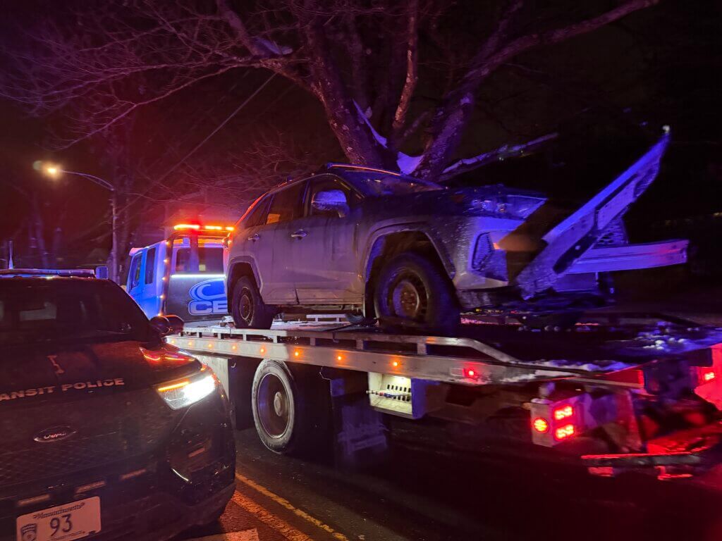A flatbed hauls away the damaged car. Photo: Celeste Katz Marston/The Acton Bridge