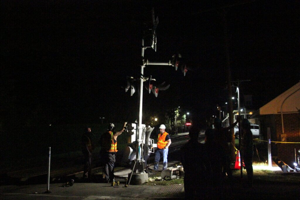 Workers make repairs to the crossing where the collision occurred. Photo: Dakota Antelman/The Acton Bridge