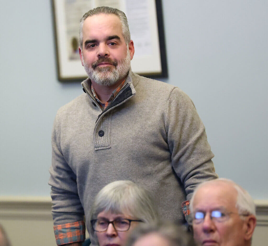 Sam Hiersteiner stands to accept after his nomination to run for Select Board during the 2026 Town Caucus at the Town House on Tuesday, January 27, 2026. Ken McGagh/The Acton Bridge