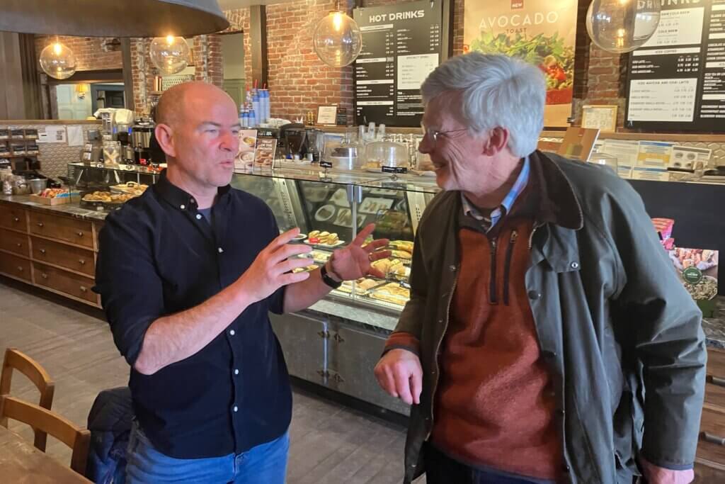 Dean Banfield, right, speaks with Community Preservation Committee member Jeff Collins at Caffè Nero in Acton Center. Photo: Dakota Antelman/The Acton Bridge