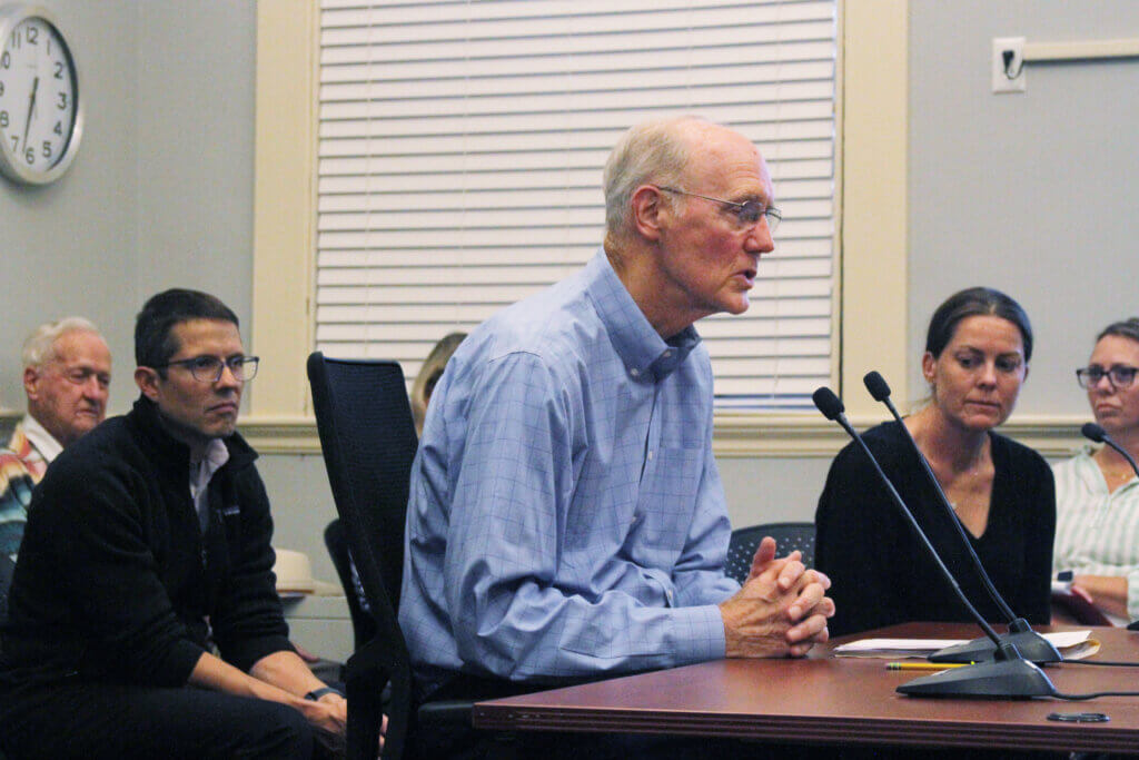 O’Donnell family friend Lowell “Sandy” Smith presents to the Select Board while Christoph and Betsy O’Donnell look on. Photo: Dakota Antelman/The Acton Bridge