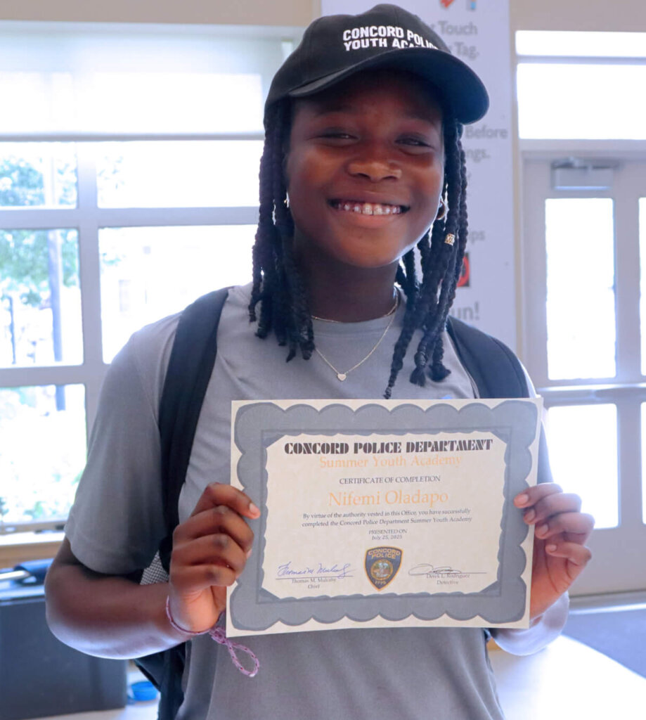 Nifemi Oladapo smiles with her academy certificate. Photo: Trace Salzbrenner/The Acton Bridge