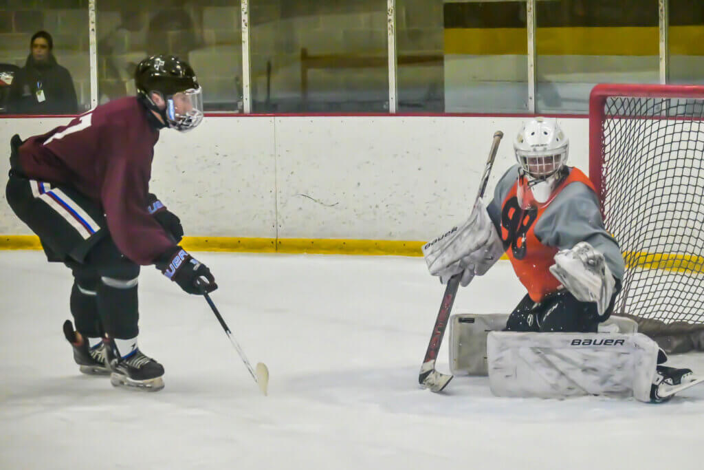 Will Richardson gloves the puck to thwart a scoring chance. Photo by David Clancy