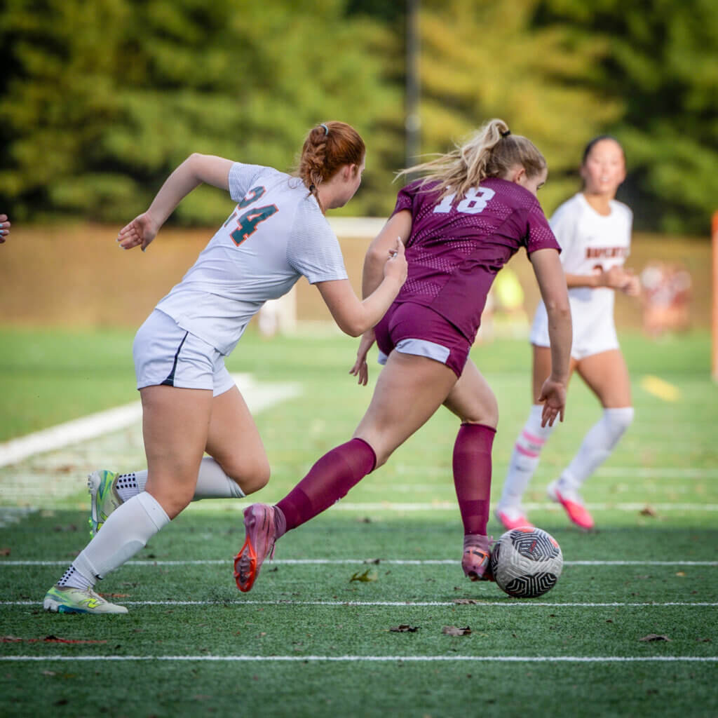 Kate Carleton (No. 18) outmaneuvers a Hopkinton opponent in the Pats’ 5-0 win on September 30. Photo by Janel Apuna
