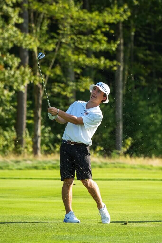 Acton-Carlisle’s Joe Grasso watches his shot fall in a match against Westford Academy on September 11 at Acton Country Club. Photo by Aidan Moroney