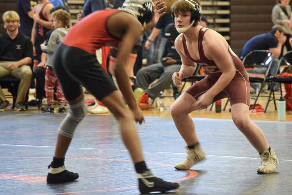 Colin Renner sizes up his opponent from Wellesley. Photo by Kim Amouzgar