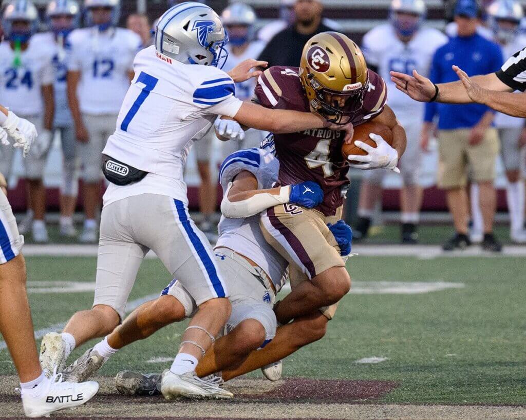 Thomas Bury (No. 4) had 13 carries for 126 yards and a touchdown for Acton-Carlisle High School against Danvers on September 5. Photo by Jon Straggas