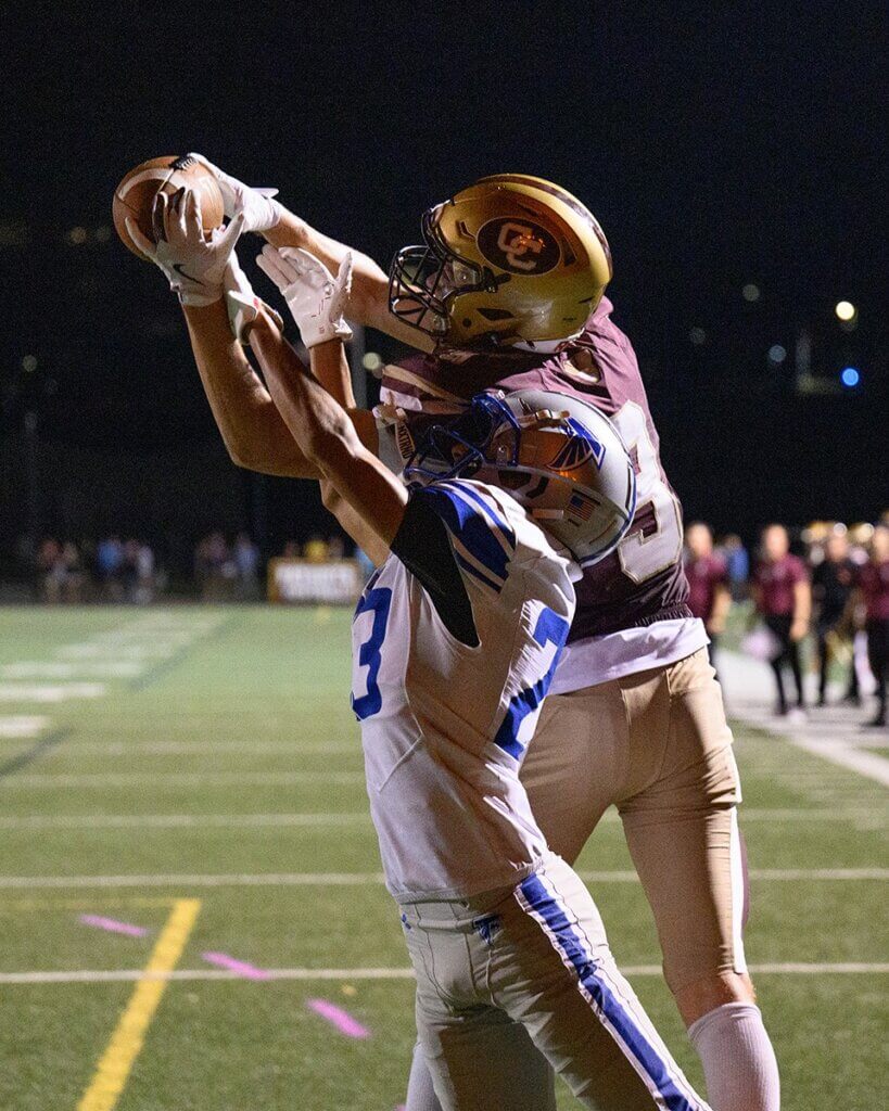 Peter Burke tries to pull down a pass as the Patriots go for a two-point conversion. Danvers’ Brandon Weeks defends. Photo by Jon Straggas