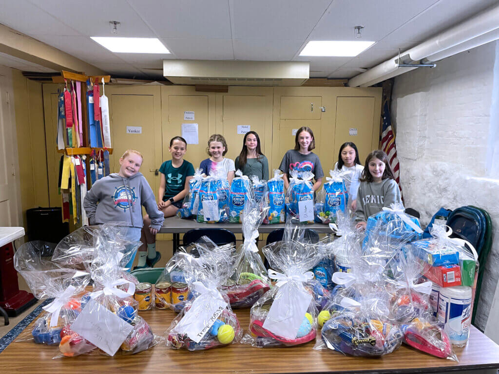 Members of Girl Scout Troop 70538 show off their pet donations. From left to right: Julia Daniel, Julia Cardinal, Sylvia Schoenfeld, Ariya Rooney, Leila Belov, Kacey Chen, and Ellie Thomas. Courtesy photo
