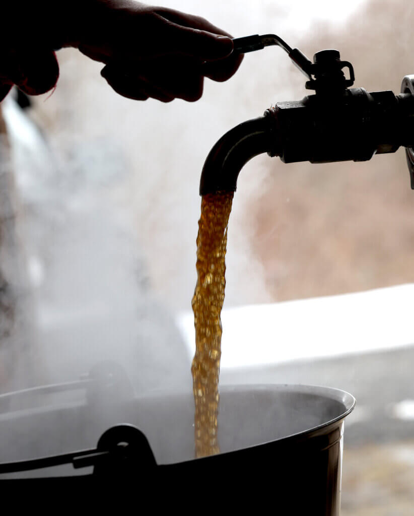 The first maple syrup of the season is poured from the evaporator into a bucket on Thursday, March 5, 2026. Ken McGagh/The Acton Bridge
