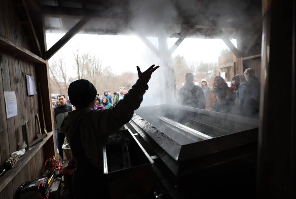 Ava Lublin, a farmer at Gaining Ground, describes the maple sugaring process to visitors during an open house on Saturday, March 7, 2026. Ken McGagh/The Acton Bridge
