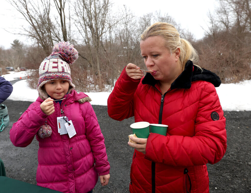Ellen Farmer of Acton and her daughter, Vera Farmer, 10, sample the Gaining Ground farm maple syrup during an open house on Saturday, March 7, 2026. Ken McGagh/The Acton Bridge