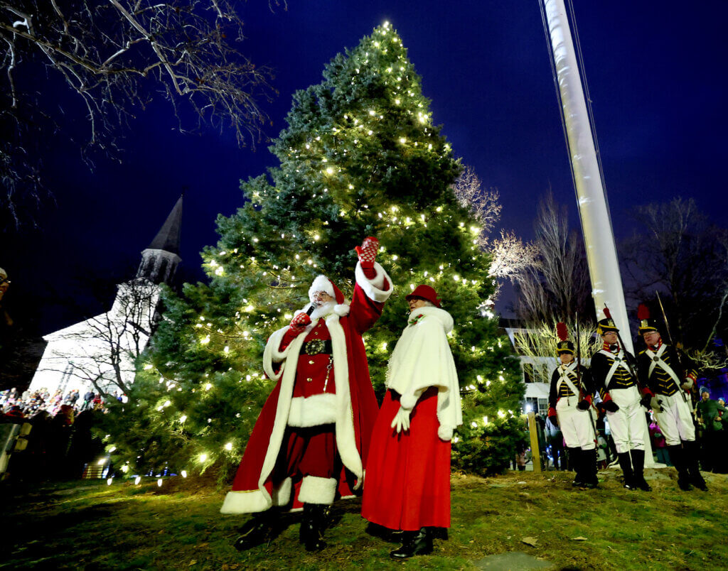 Santa Claus waves to the crowd after lighting the town’s Christmas tree in Monument Square during the town’s annual Tree Lighting on Sunday, December 7, 2025. Ken McGagh/The Acton Bridge