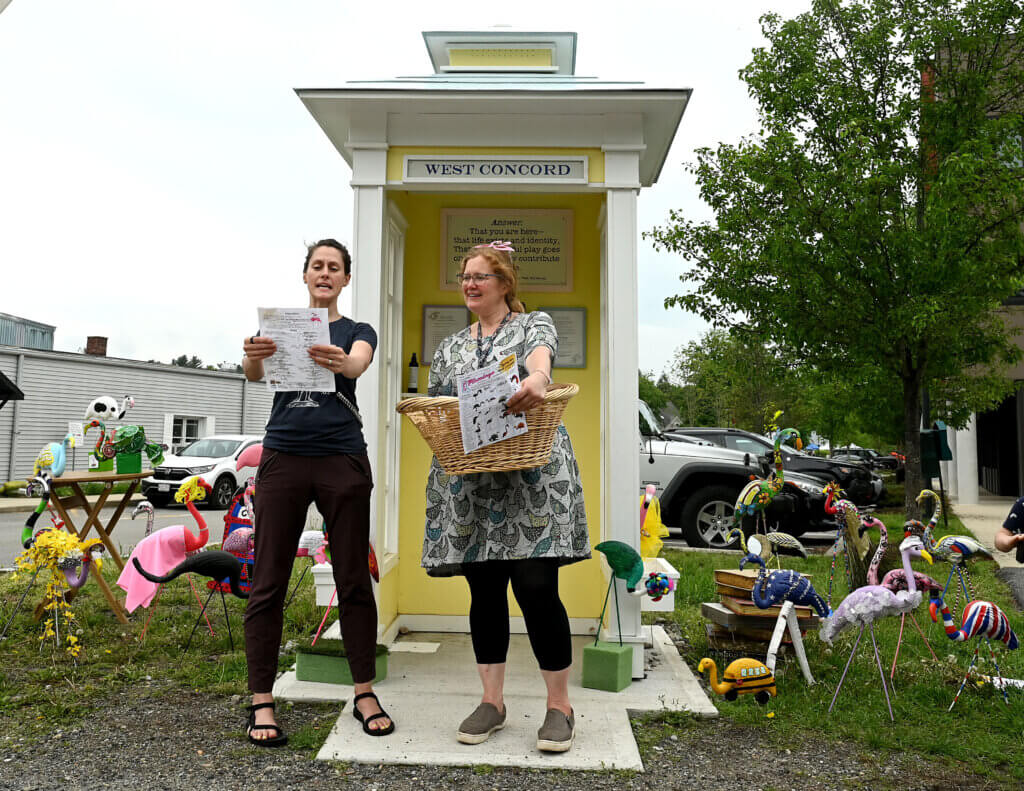 Kara Ebbutt, left, of Art for All, and Fowler Branch librarian Dorrie Karlin read off raffle prize winners from among the contestants in the Flamingo Bingo scavenger hunt. Forty plastic birds were spread out in West Acton businesses for attendees to find.