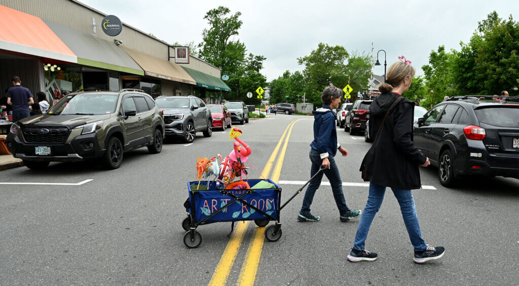 Sue LaChance, center, and Deb Richardson of Art For All cross Commonwealth Avenue as they collect flamingos. Flamingo Bingo was the theme of this year’s Art for All scavenger hunt.