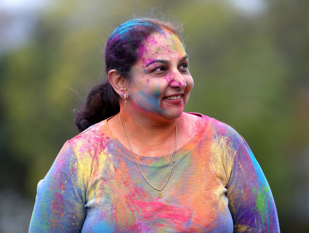 Roopa Kotian of Acton is well-covered in powder after participating in a Holi Celebration at the Alcott Eleme ntary School playground on Saturday, May 2, 2026. Ken McGagh/The Acton Bridge