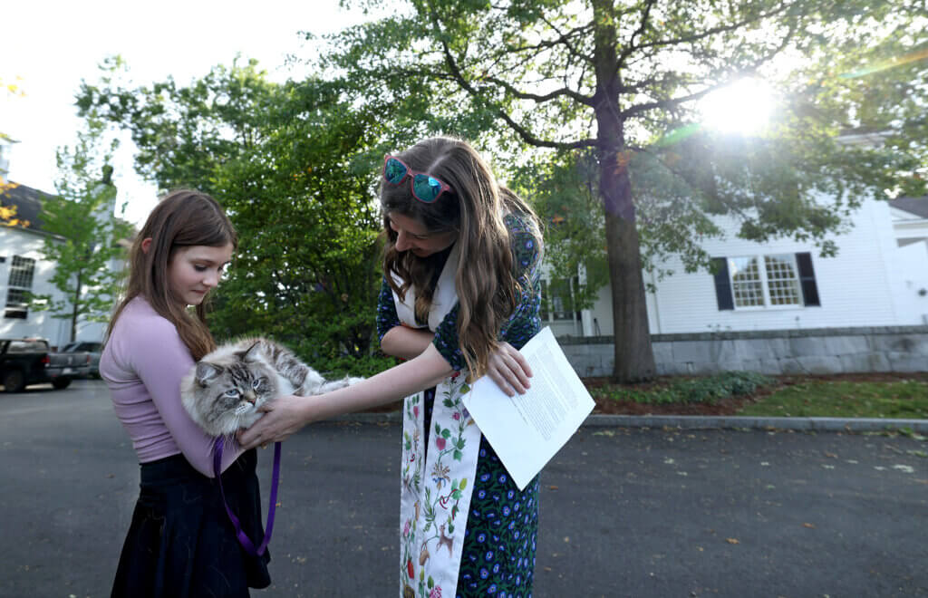 Vivian Irwin, 12, of Acton, holds her Siberian cat Otto as Rev. Rebecca Floyd Marshall offers a blessing during the annual Blessing Of The Animals ceremony at Trinitarian Congregational Church in Acton Sunday, September 21, 2025. Ken McGagh/The Acton Bridge