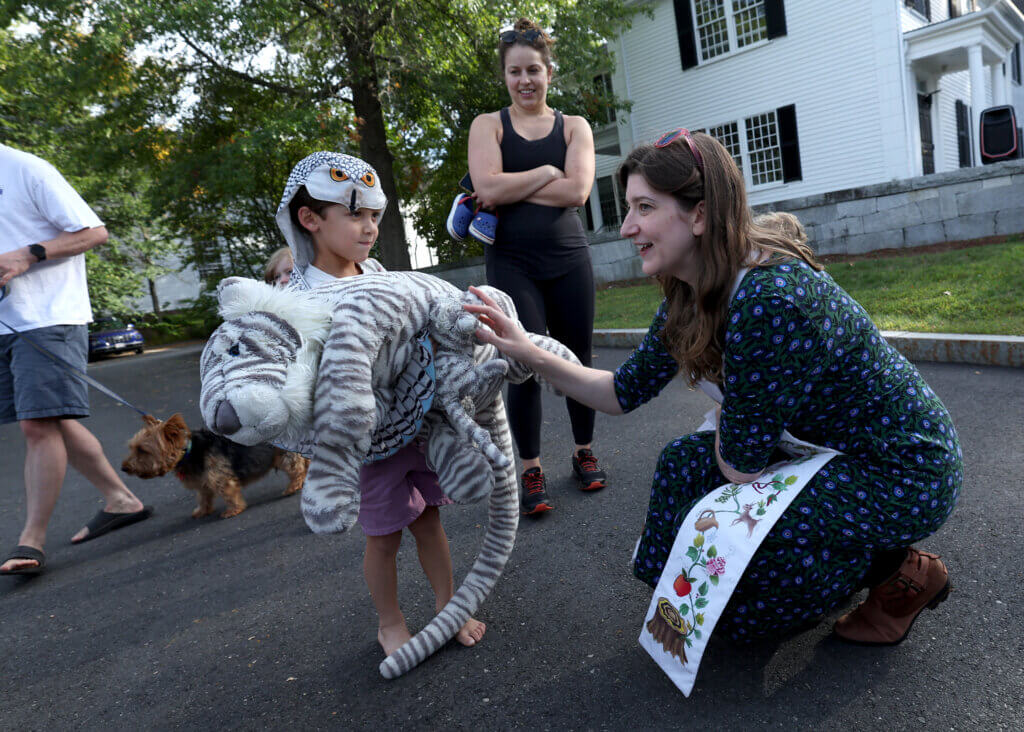 Rev. Rebecca Floyd Marshall blesses a mommy stuffed tiger belonging to Miles Hegg, 5, of Acton, as Miles’ mother Katie Takvorian looks on, on during a Blessing Of The Animals ceremony at Trinitarian Congregational Church in Acton Sunday, September 21, 2025. Rev. Marshall also blessed Miles’ owl costume and baby stuffed tiger. People were encouraged to bring their pets, pictures of pets or stuffed animals to be blessed by clergy Sunday. Ken McGagh/The Acton Bridge