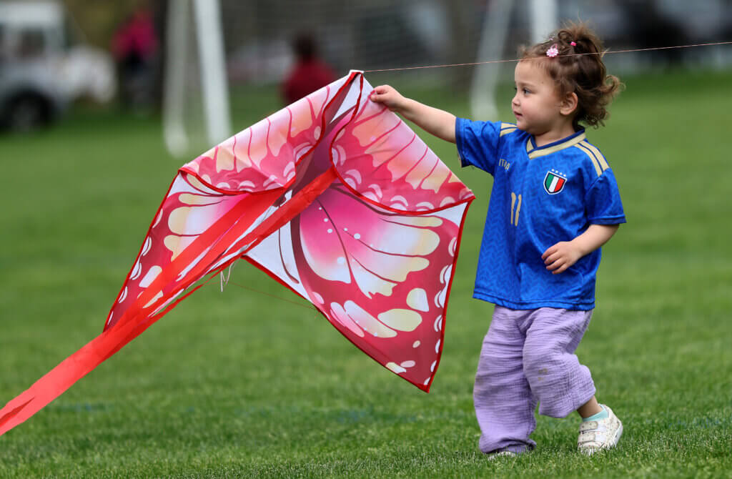 Nori Wyant, 2, of Acton, prepares to launch her kite during the Acton Recreation Department’s Kite Festival at Rideout Park in West Acton on Saturday, May 2, 2026. Ken McGagh/The Acton Bridge