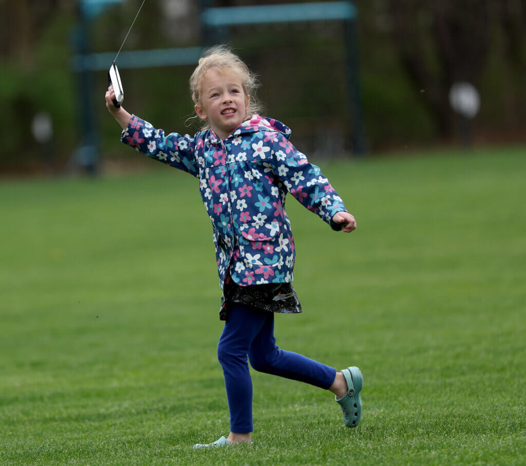 MJ Fitzgerald, 5, runs with her kite during the Acton Recreation Department’s Kite Festival at Rideout Park in West Acton on Saturday, May 2, 2026. Ken McGagh/The Acton Bridge