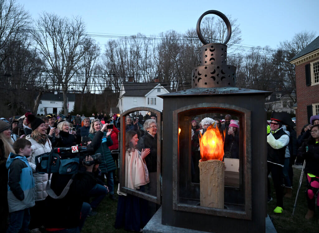 The crowd applauds moments after the lighting of the Concord250 lantern. Photo: Ken McGagh/The Acton Bridge
