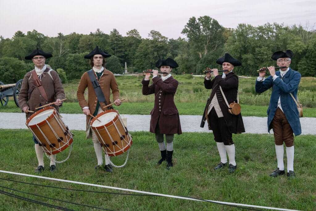 Fifers and drummers play. Minute Man National Historical Park, cannon firing in honor of the Declaration of Independence. Jon Chase photo