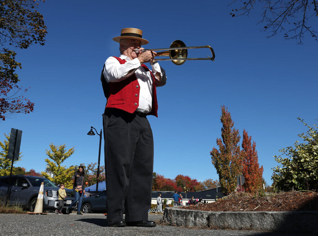 Trombone player Ron L’Herault of the Lincoln Traditional Jazz Band warms up under blue skies for his set at Discover West Acton Day on Saturday, October 18, 2025. Ken McGagh/The Acton Bridge