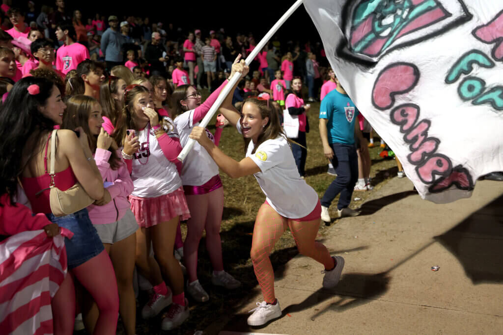  A CCHS flagbearer rallies the fans.

