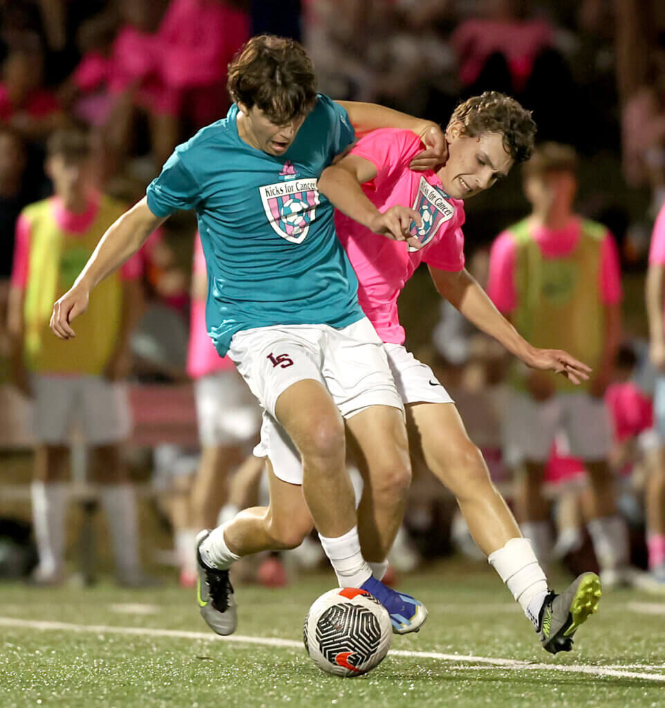 Acton-Carlisle’s Ben Hackman, right, battles a Lincoln-Sudbury player.
