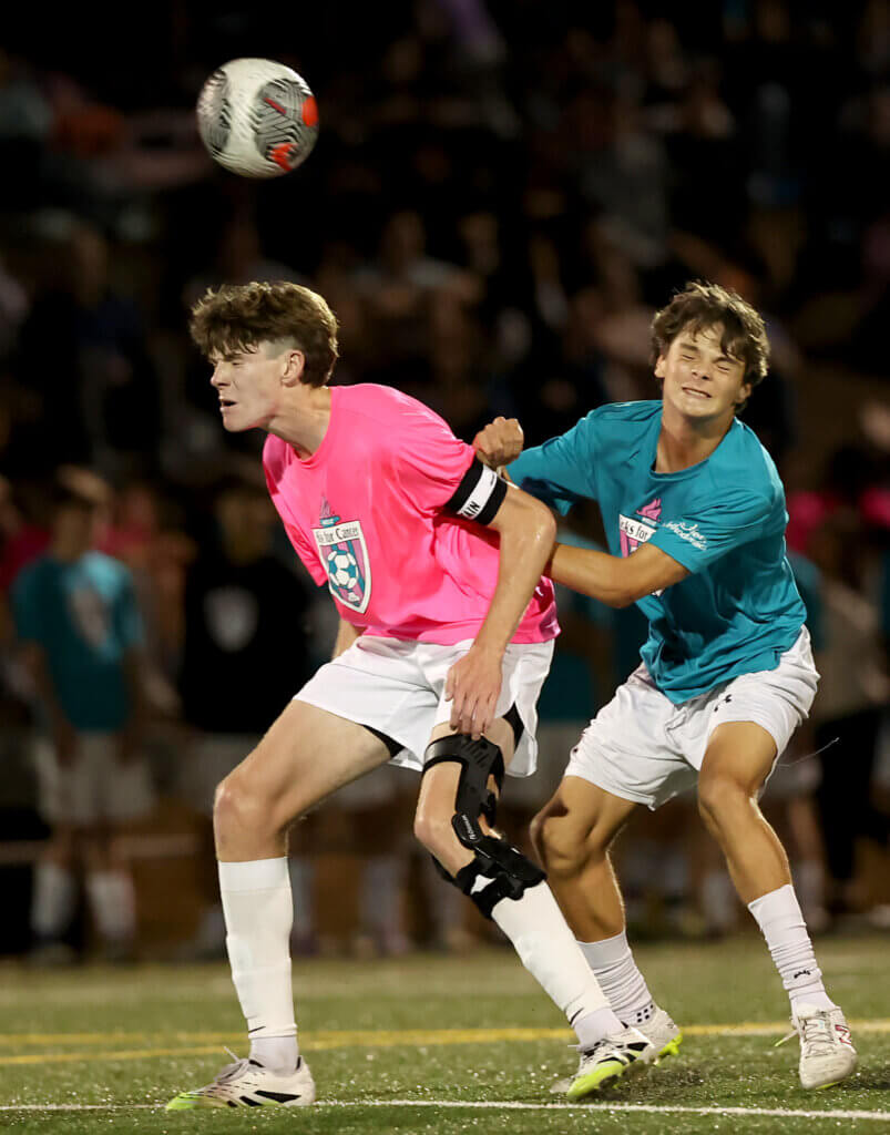 CC senior captain Tyler Shepard, left, heads the ball.
