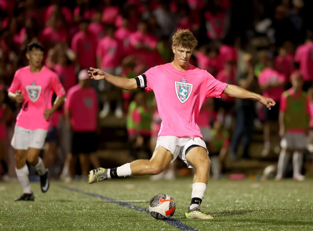 Patriots senior captain Timmy Stone passes the ball during the match against Lincoln-Sudbury.
